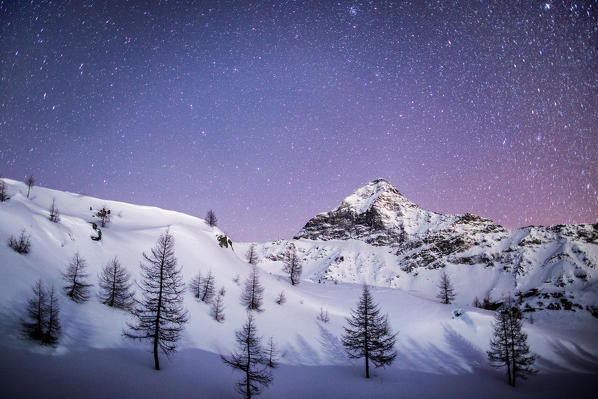 Amazing starry sky over the Scalino peak seen from Prabello alp.  Valmalenco, Valtellina, Sondrio, Lombardy, Italy Europe