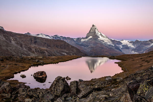 Pink sky at sunrise on the Matterhorn reflected in Stellisee. Zermatt Canton of Valais Pennine Alps Switzerland Europe