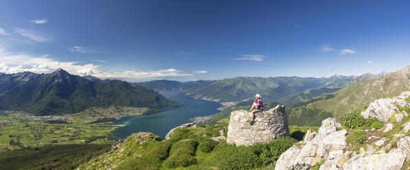 Panoramic of hiker on Monte Berlinghera looking to Colico, Monte Legnone and Monti Lariani, Sondrio province, Lombardy, Italy