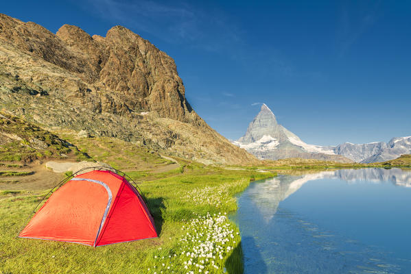 Tent on the shore of lake Riffelsee facing Matterhorn, Zermatt, canton of Valais, Switzerland