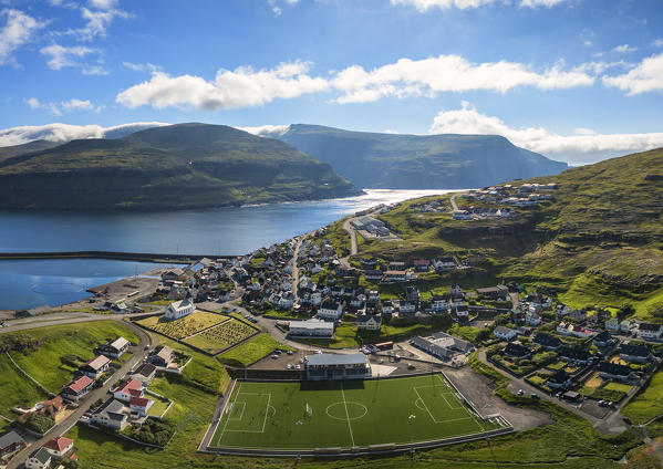 Panoramic aerial view of soccer field in the village of Eidi, Eysturoy island, Faroe Islands, Denmark