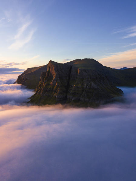 Aerial panoramic of clouds above the rocky peaks, Gasadalur, Vagar island, Faroe Islands, Denmark