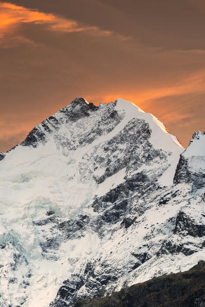 Sunset above Piz Bernina and the snowy crest of Biancograt, Pontresina, Engadine, canton of Graubunden, Switzerland