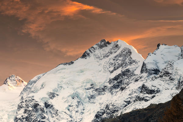 Sunset above Piz Bernina and the snowy ridge of Biancograt, Pontresina, Engadine, canton of Graubunden, Switzerland
