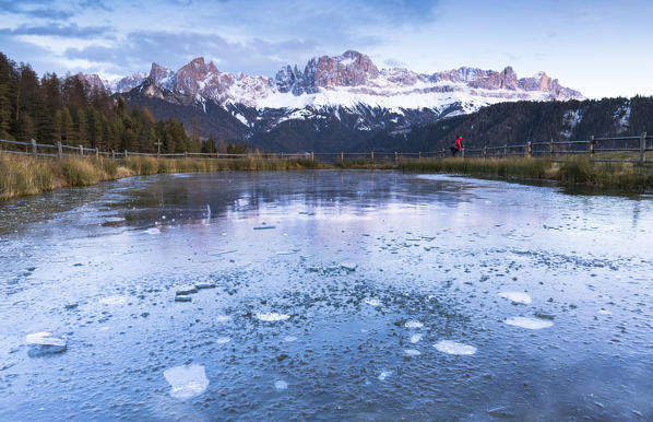 A beautiful sunset on the Rosengarten with a iced lake in foreground, Bolzano province, South Tyrol, Trentino Alto Adige, Italy