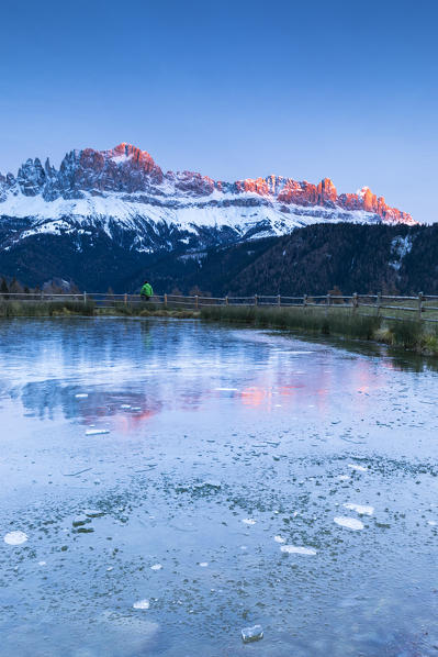 A beautiful sunset on the Rosengarten with a iced lake in foreground, Bolzano province, South Tyrol, Trentino Alto Adige, Italy