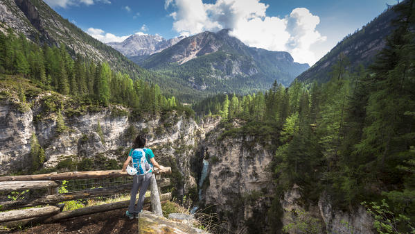 A hiker is staring into the Fanes Falls near Cortina d'Ampezzo, Belluno province, Veneto, Italy