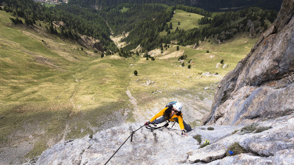 a hiker is climber on the Mount Rodella (Col Rodella) along the via ferrata, Trento province, Trentino, Italy 