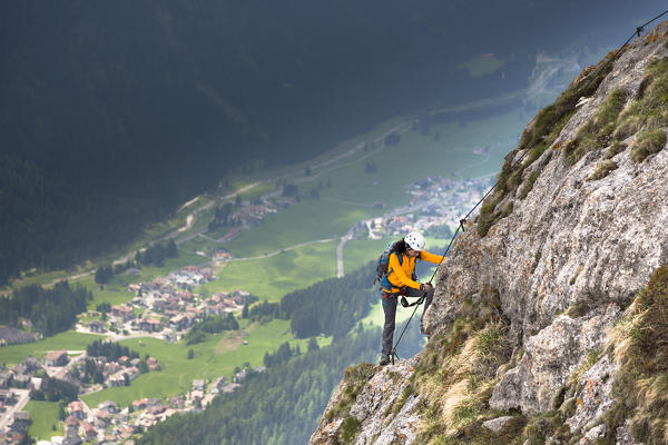 a hiker is climber on the Mount Rodella (Col Rodella) along the via ferrata, Trento province, Trentino, Italy