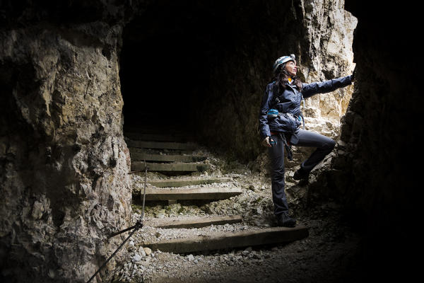 a hiker along the Lagazuoi Gallery, a long gallery builted by the italian alpine troopers during the world war 1, Belluno province, Veneto, Italy
