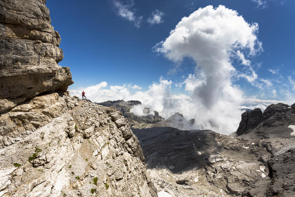 a hiker along the Via delle Bocchette, the famous via ferrata on the Brenta Group, Trento province, Trentino, Italy