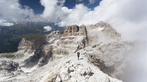 a hiker along the Via delle Bocchette, the famous via ferrata on the Brenta Group, Trento province, Trentino, Italy