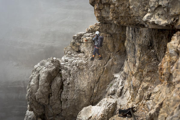 a hiker along the Via delle Bocchette, the famous via ferrata on the Brenta Group, Trento province, Trentino, Italy