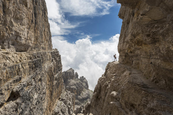 a hiker along the Via delle Bocchette, the famous via ferrata on the Brenta Group, Trento province, Trentino, Italy