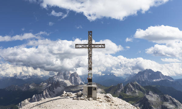 the iron cross on the top of the Tofana di Rozes witha stunning landscape around it, belluno province, veneto, italy