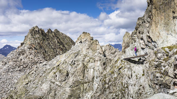 a hiker on a wood bridge along the via ferrata 
