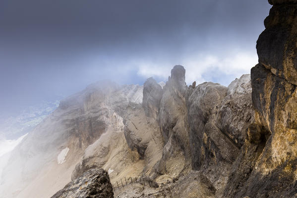  a suggestive view of the Tofana di Mezzo with some climbers along the via ferrata Gianni Aglio, Belluno province, Veneto, Italy