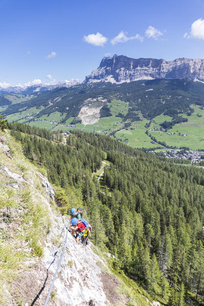 a group of hikers are climbing the via ferrata (iron path) Les Cordes in the Dolomites, Bolzano province, South Tyrol, Trentino Alto Adige, Italy