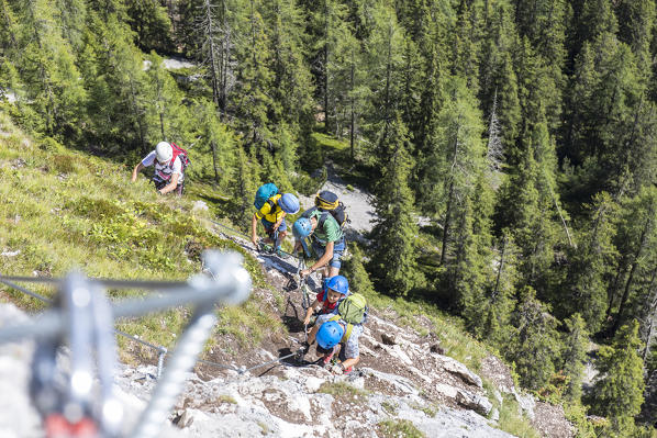 a group of hikers are climbing the via ferrata (iron path) Les Cordes in the Dolomites, Bolzano province, South Tyrol, Trentino Alto Adige, Italy