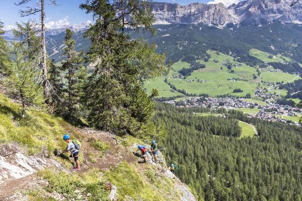 a group of hikers are climbing the via ferrata (iron path) Les Cordes in the Dolomites, Bolzano province, South Tyrol, Trentino Alto Adige, Italy
