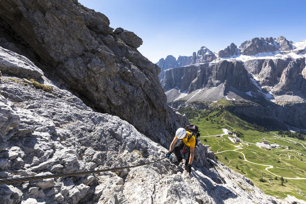 a climber along the via ferrata Gran Cir with the Sella Group in the background, Bolzano province, South Tyrol, Trentino Alto Adige, Italy