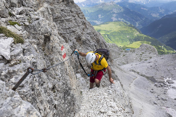 A climber along a via ferrata on the Sella Group, Bolzano province, South Tyrol, Trentino Alto Adige, Italy