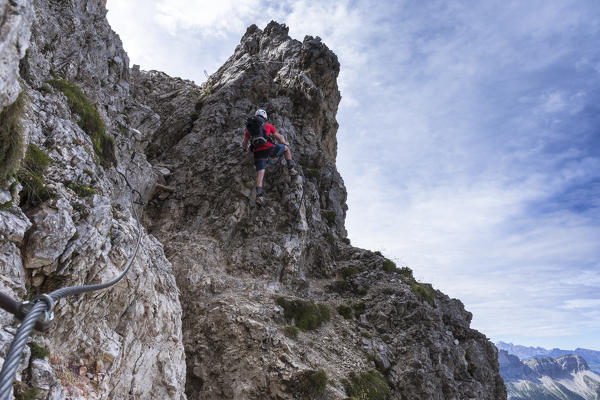 A climber along the via ferrata Günther Messner on the Aferer Geisler, Bolzano province, South Tyrol, Trentino Alto Adige, Italy