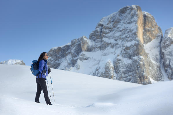 view of a model on a snow hill with Pale di San Martino in background, Trento province, Trentino Alto Adige, Italy, Europe