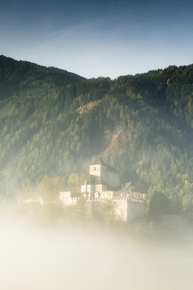 an autumnal view of Raifenstein Castle (Castel Tasso) surrounded by the mist, Bolzano province,southern Wipptal, South Tyrol, Italy, Europe, Trentino Alto Adige
