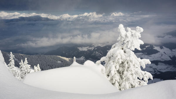 a suggestive landscape through the Valley of Eisack till the Austrian Alps after a recent snowfall. Eisack, Valley of Eisack, Bolzano province, South Tyrol, Trentino Alto Adige, Italy, Europe