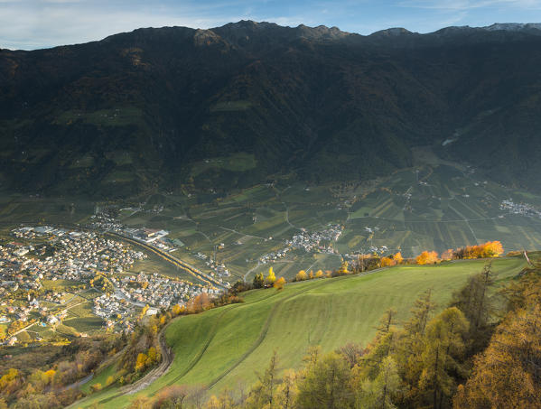 an autumnal aerial view of the village of Naturns in the sunset light, Vinschgau, Bolzano province, South Tyrol, Trentino Alto Adige, Italy, Europe
