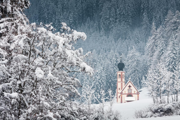 a suggestive winter image of the Church of St. John in Ranui, Villnössertal, Bolzano province, South Tyrol, Trentino Alto Adge, Italy, Europe