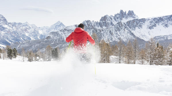 a view of a hiker running into the fresh snow with his snowshoes, Belluno province, Veneto, Italy, Euroope