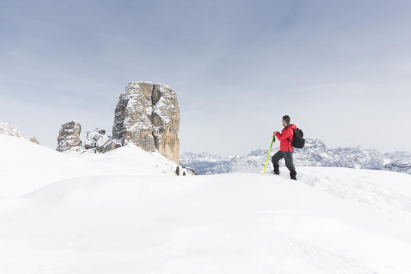 a view of a hiker with snowshoes looking at the Cinque Torri, Belluno province, Veneto, Italy, Europe