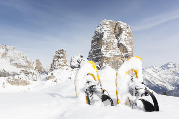 a view of the famous dolomitic group called Cinque Torri, with a pair of snowshoes in the foreground, Belluno province, Veneto, Italy, Europe