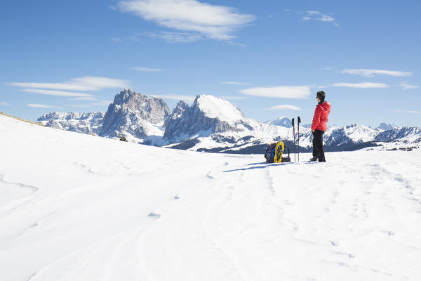 a view of a hiker with snowshoes with looking to Langkofel Group, Bolzano province, South Tyrol, Trentino Alto Adige, Italy, Europe