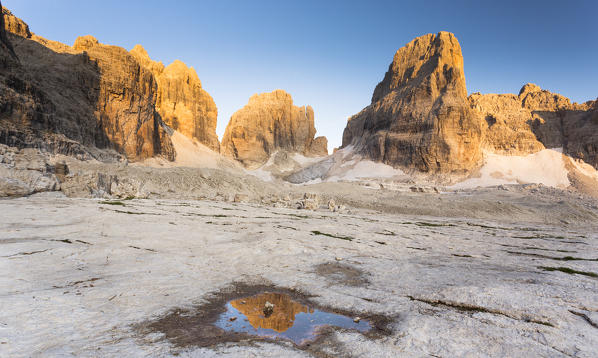 a beautiful sunset on the Brenta's peaks, refrected on a small puddle, Trento province, Trentino Alto Adige, Italy, Europe, 