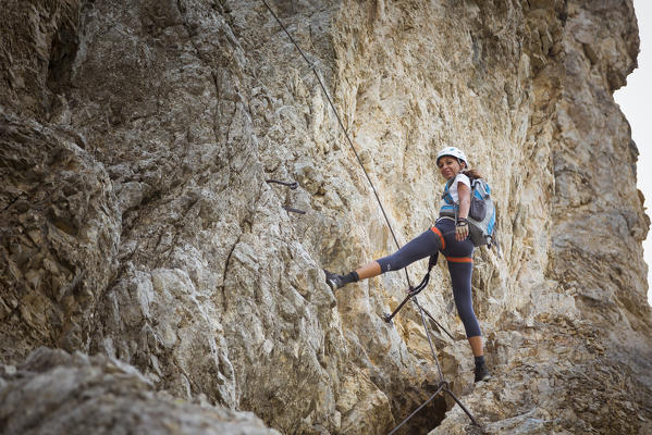 a hiker is climbing a very hard via ferrata, Trento province, Trentino Alto Adige, Italy