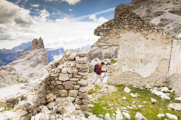 a hiker is walking on the Tofana di Rozes through the ruins of the World War I, Belluno province, Veneto 