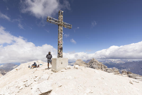 a view of the Tofana di Rozes Peak with two hikers, Belluno province, Veneto, Italy