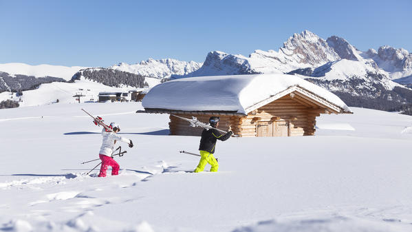 two skier are walking into fresh snow on the Seiser Alm, Bolzano province, South Tyrol, Trentino Alto Adige, Italy