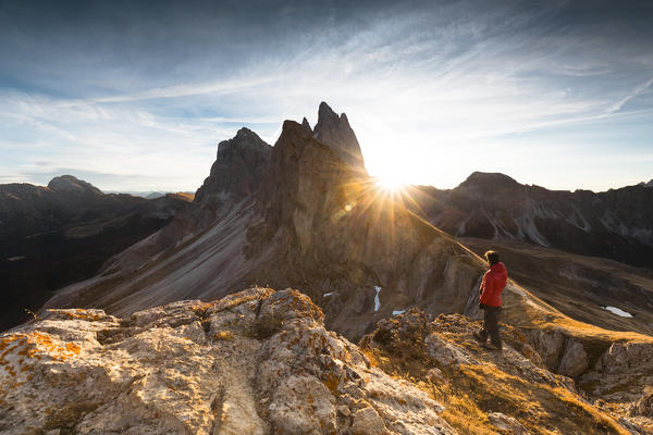a beautiful sunrise on the Dolomites: the sun comes out behind the Geisler Group, Bolzano province, South Tyrol, Trentino Alto Adige, Italy