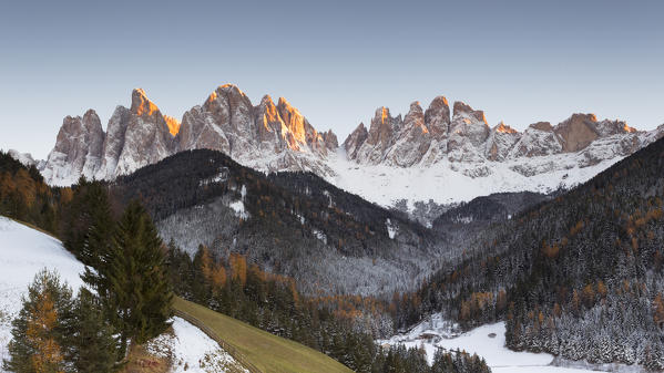 an autumnal sunset in Villnössertal after the first snowfall with the Geisler Group in the background, Bolzano province, South Tyrol, Trentino Alto Adige, Italy