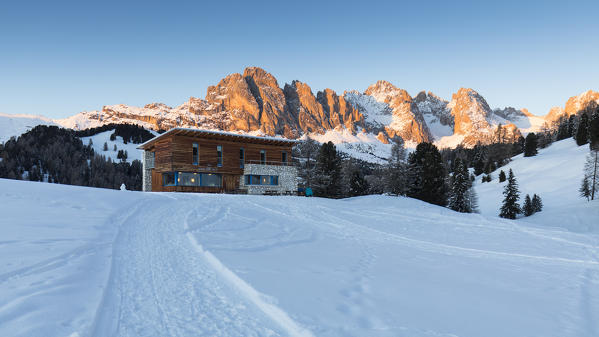 a winter sunset on the Geisler Group in Val Gardena with Juac Hut in the foreground, Bolzano province, South Tyrol, Trentino Alto Adige, Italy,
