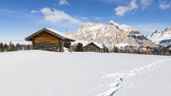 a typical alpine winter pasture in Val Badia with two huts and the Piz dles Cunturines in the background, Bolzano province, South Tyrol, Trentino Alto Adige, Italy