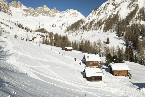 the typical mountain huts in Valfredda, a dolomitic valley near the San Pellegrino Pass, Belluno province, Veneto, Italy