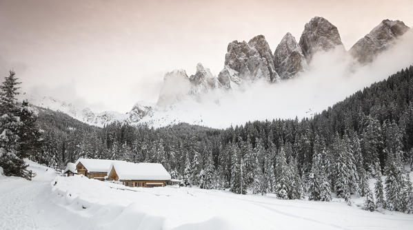 a winter view of the Geisler Group in Villnössertal surrounded by the mist, Bolzano province, South Tyrol, Trentino Alto Adige, Italy