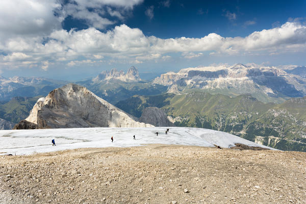 a beautiful landscape from the top of the Marmolada with a group of hikers walking on a glacier, Trento province, Trentino Alto Adige, Italy,