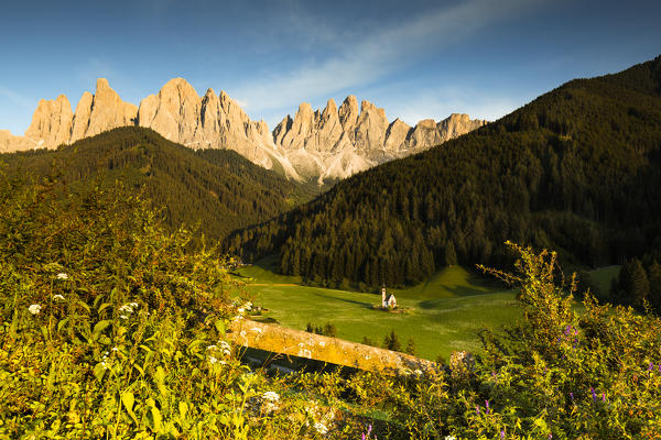 a suggestive sunset in Villnössertal with the Geislergruppe in the background and the famous church of St. John, Bolzano province, South Tyrol, Trentino Alto Adige, Italy,