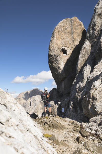 a hiker is looking at the military observatory along the via ferrata Bepi Zac on the battlefront of the World War One into the Marmolada Group, Trento Province, Trentino Alto Adige, Italy